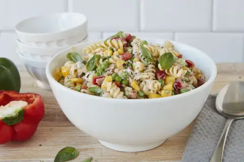Ein bunter Nudelsalat ohne Mayo, mit Spiralnudeln, Erbsen, Mais, Paprika und frischem Basilikum.