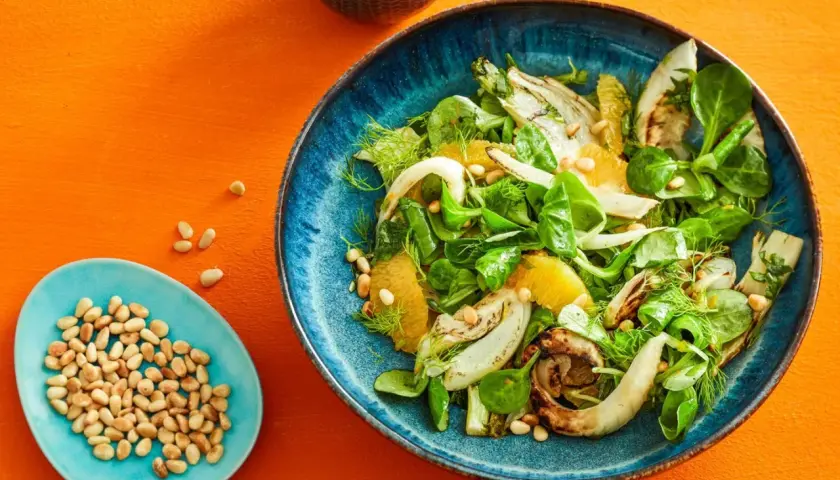 Erfrischender Fenchel-Orangen-Salat mit Pinienkernen, garniert mit Dill.