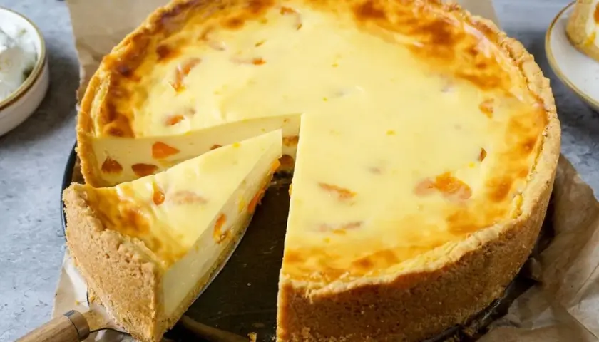 Ein saftiger Mandarinen Schmand Kuchen mit einem knusprigen Boden und einer cremigen Füllung, verziert mit saftigen Mandarinenstücken.